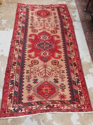 Lot 1022 - Eastern rug with geometric decoration on red, blue and beige ground, 210cm x 107cm