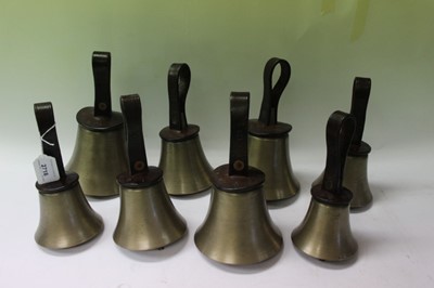 Lot 2718 - Set eight graduated hand bells with leather strap handles