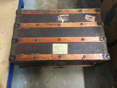 Lot 145 - A vintage trunk containing sundry items, including navy canvas kit bags, two Turkish rugs, etc