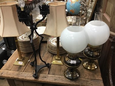 Lot 93 - Two pairs of brass oil lamp style table lamps, two pairs of brass candlesticks table lamps and a gothic wrought metal lamp