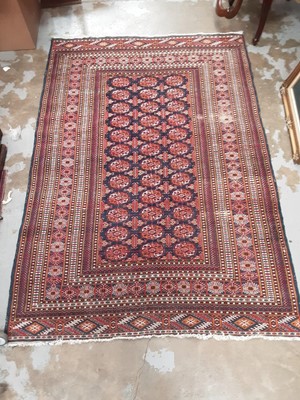Lot 1139 - Eastern rug with geometric decoration on red and blue ground, 183cm x 127cm