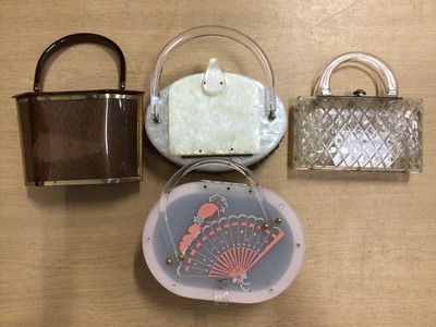 Lot 2094 - Four vintage c1950's Lucite handbags. Including clear lattice work with rhinestones and bronze coloured bag by Majestic.
