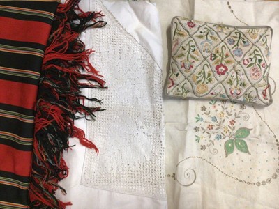 Lot 2111 - A quantity of table linens including crochet edge table cloths, embroidered cloths, pulled thread work etc.  Plus a stripped red wool cover with fringing.