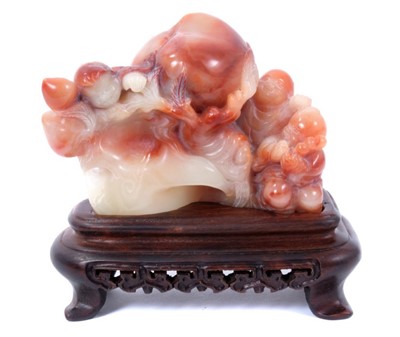 Lot 757 - Chinese carved hardstone group of deity figures and a peach, raised on wooden stand