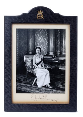 Lot 9 - H.M.Queen Elizabeth II, fine signed presentation portrait photograph of The Queen seated in Buckingham Palace , signed in ink on mount 'Elizabeth R 1975' in original leather frame with dome top wi...
