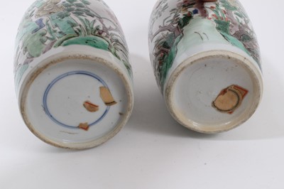 Lot 101 - A near pair of Chinese famille verte ovoid porcelain vases, Kangxi (1662-1722), decorated with flowers, birds and rockwork, with carved wooden covers, one with a double-ring mark to base, 23.5cm an...