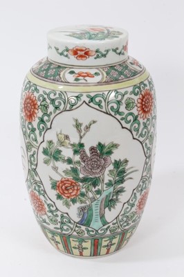 Lot 106 - Chinese famille verte ovoid porcelain vase and cover, 19th century, decorated with panels of flowers on a scrolling foliate-patterned ground, 21cm high