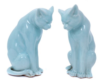 Lot 112 - Good pair of Japanese clair de lune glazed porcelain models of cats, probably early 20th century, shown seated with tails at their sides, 24cm high