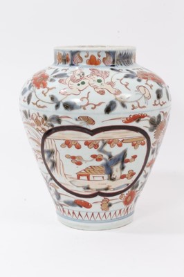Lot 118 - Japanese Imari porcelain vase, 18th century, decorated with landscape panels, stylised flowers and foo dogs, 23cm high