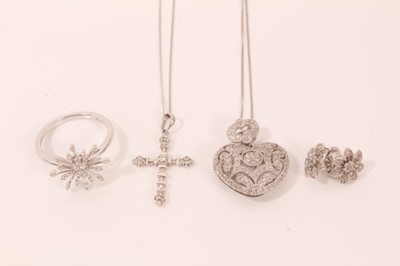 Lot 79 - Group 9ct white gold diamond set jewellery to include heart locket on chain, cross pendant on chain, pair flower stud earrings and a starburst ring