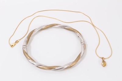 Lot 85 - 9ct yellow and white gold twisted bangle and 9ct gold chain with yellow stone pendant