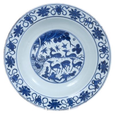 Lot 289 - Chinese blue and white dish, 17th century, boldly painted with five deer in a landscape, the rim with auspicious symbols and flowers, the reverse with pomegranates and flowers, seal mark to base, 3...