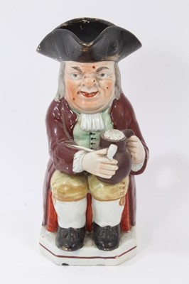 Lot 192 - Staffordshire pearlware-glazed Toby jug, circa 1820, typically modelled and polychrome painted, 25cm high
