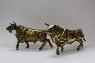 Lot 2479 - Two large and very heavy brass models of bulls