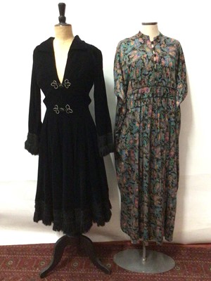 Lot 2142 - 1970's Nette Vouges black velvet cocktail dress with fringing to cuffs and hem plus 1970's printed paisley batwing dress.