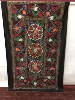 Lot 2144 - Two large black cotton wall hangings hand embroidered flowers, rounds, hearts in chain stitch.