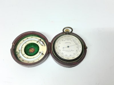 Lot 2509 - Late 19th / early 20th century pocket barometer by Lawrence & Mayo, London, 5cm diameter, in leather case with thermometer to underside of lid