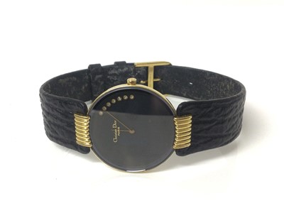 Lot 77 - Christian Dior wristwatch, the circular matte black dial set with brilliants, in circular gold plated case with reeded lugs, on original black leather strap with Christian Dior buckle, case 30mm di...