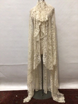 Lot 2179 - Antique wedding Veil, net ground with handmade bobbin lace scrolling flowers and scalloped edges.