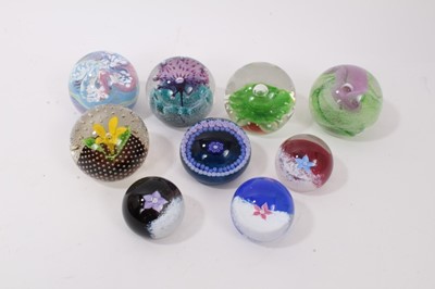 Lot 1219 - Nine Caithness Paperweights including Calypso, Amethyst Lace, Flower in the Rain, Fountain, Fleur, Sentinel Emerald and Multi coloured pattern. (9)