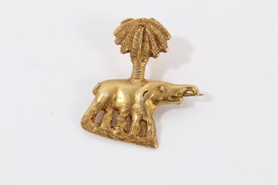 Lot 204 - Two Middle Eastern yellow metal rings, yellow metal elephant palm tree brooch and yellow metal filigree butterfly brooch (4)