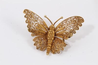 Lot 204 - Two Middle Eastern yellow metal rings, yellow metal elephant palm tree brooch and yellow metal filigree butterfly brooch (4)