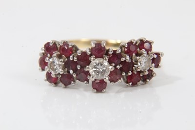 Lot 248 - 18ct gold ruby and diamond triple flower head cluster ring
