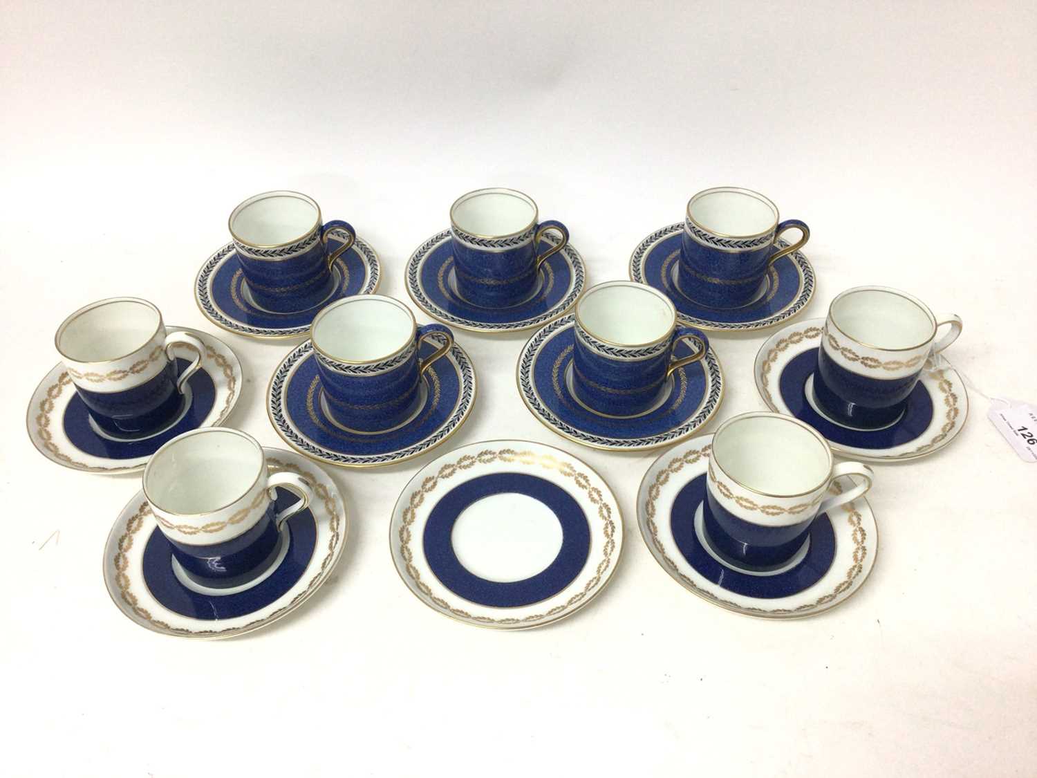 Lot 79 - Wedgwood five-person coffee set, decorated with gilt foliate patterns on a powder blue ground, together with a similar four-person Bisto coffee set, with one extra saucer