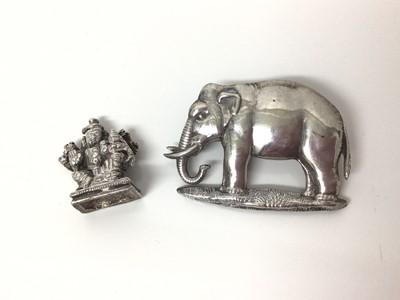 Lot 143 - Early 20th century white metal mount of an elephant, 5cm x 3.5cm, together with an antique Indian white metal deity, 2.5cm high