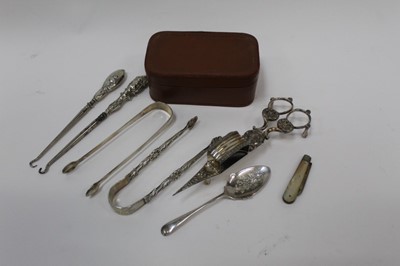 Lot 2539 - Group of silver to include two pairs of Georgian sugar tongs, silver fruit knife, silver button hooks, grapefruit spoon and silver plated candle snuffers.