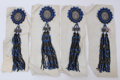 Lot 2159 - 1920's Set of Four Large Beaded Dress ornamentation. Unused and mounted on waxed cotton pieces.  Hand written label states Blue and Jet with 'Silver' centres.