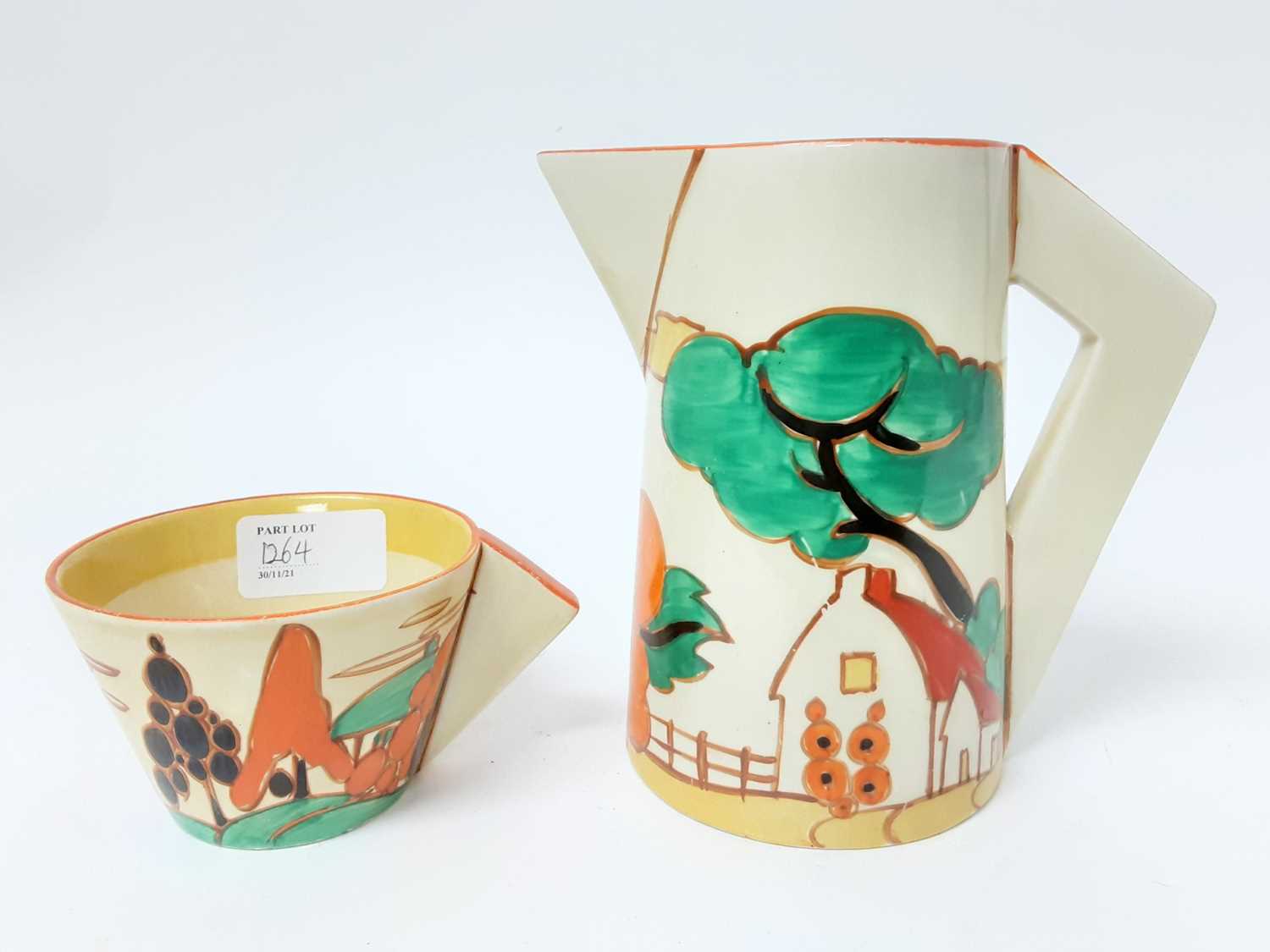 Lot 1264 - Clarice Cliff Bizarre range Fantasque milk Jug and cup (2)