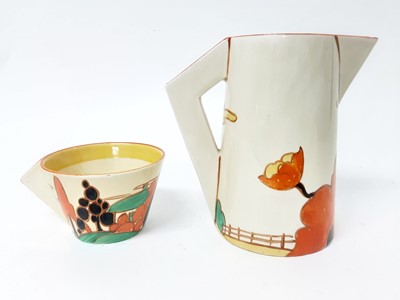 Lot 1264 - Clarice Cliff Bizarre range Fantasque milk Jug and cup (2)