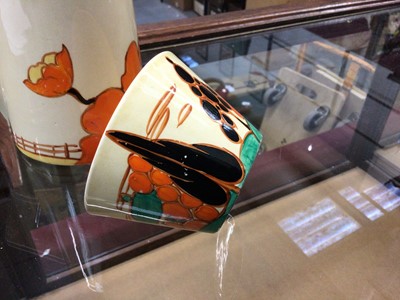 Lot 1264 - Clarice Cliff Bizarre range Fantasque milk Jug and cup (2)