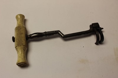 Lot 2550 - 19th century steel tooth key with bone handle carved with a cross hatch pattern, 15cm long