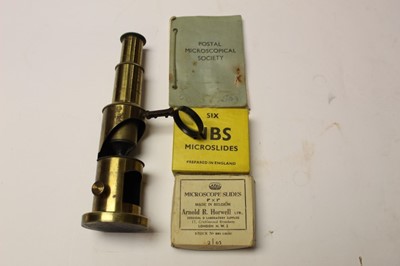 Lot 2569 - Brass microscope with bulls eye lens, together with slides and a book of notes