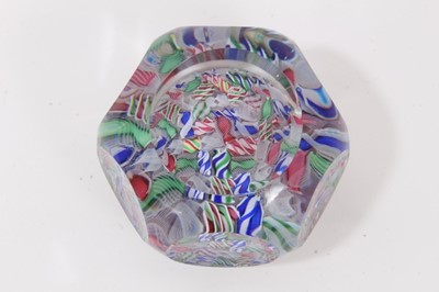 Lot 306 - Unusual Baccarat glass paperweight, circa 1850, the clear glass dome with six windows to top and sides above the motif of a laid ground of canes upon a raised cushion, 78mm diameter